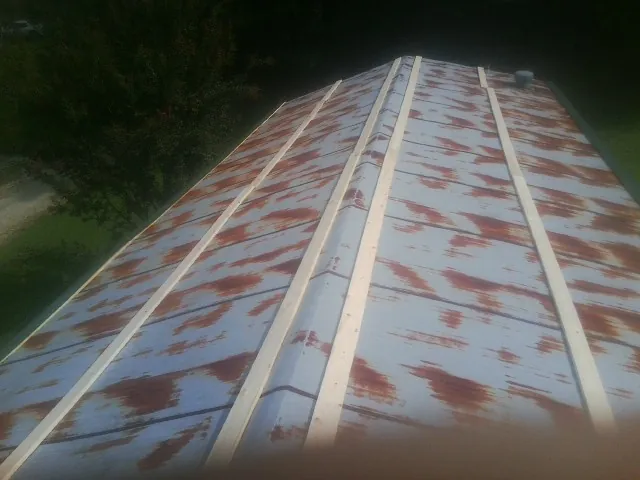 Rusted metal roof panels with new wood purlins before replacement — Storm Damage Roof Repair in Foxboro by Roofing Brothers